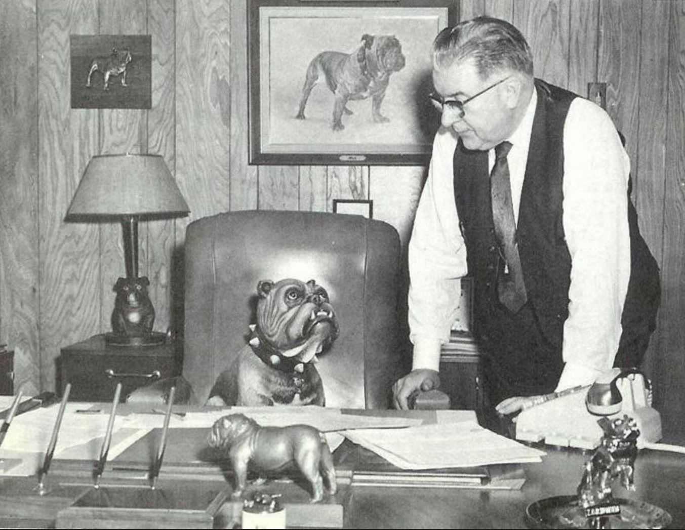 A photo of Zenon C.R. Hansen at his desk with his bulldog.